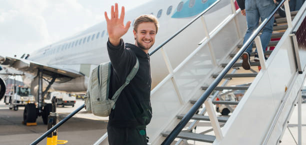 Happy man boarding a plane