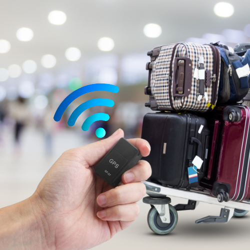 Luggage on an airport trolley and the GPS MiniTracker in a hand in use in front of them