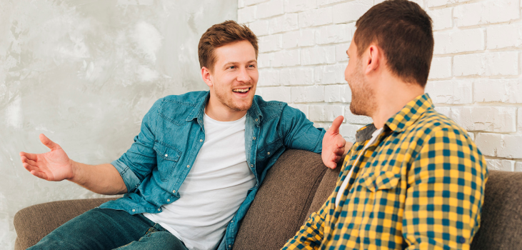 image of 2 men having a conversation on a couch